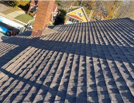 A newly installed Barkwood Timberline Natural Shadow shingle roof in Mount Lookout, OH, featuring textured asphalt shingles with sunlight and shadows creating a dimensional effect.