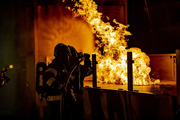 two firefighters trying to put down a fire 