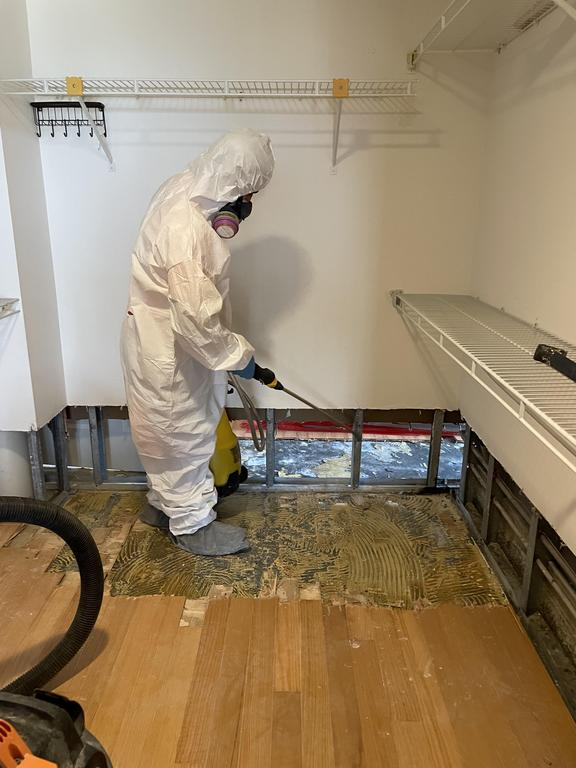 A water damage restoration professional at work