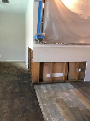 photo of damaged wall and flooring inside a house 