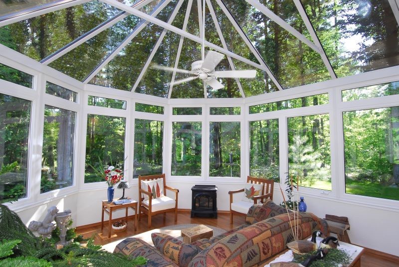 Looking out of a sunroom with glass walls and ceiling