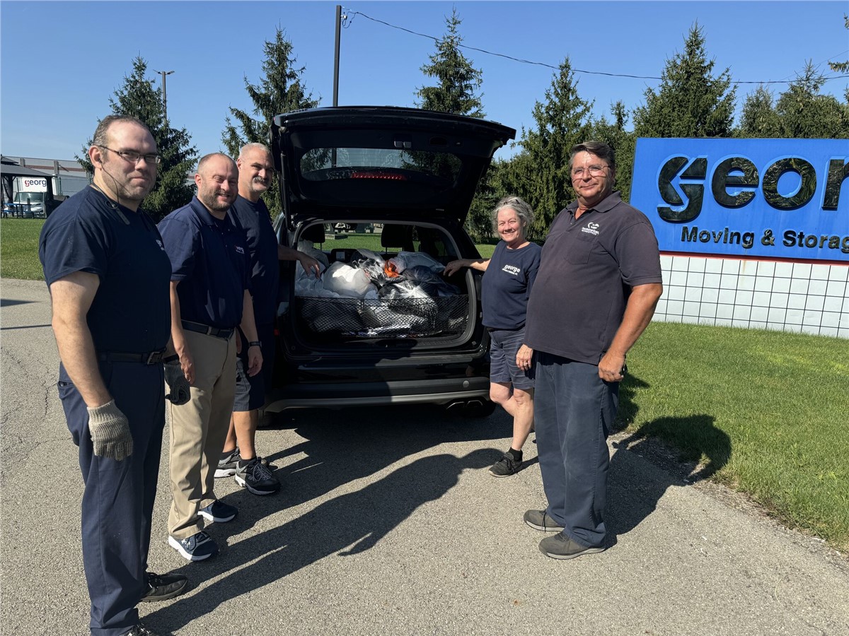 George Moving & Storage donates 30 winter coats to the Red Door of Pittsburgh