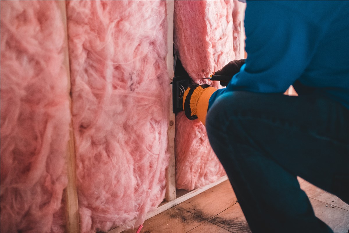 Installing new batt insulation in the attic of a home. 