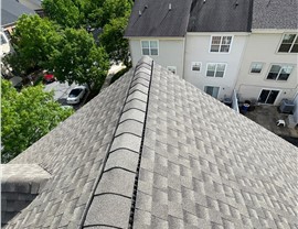 Home in Rockville, MD with a newly installed roof featuring Weathered Wood Timberline HDZ shingles, blending seamlessly with the natural surroundings.