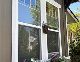 Two new energy-efficient replacement double hung windows recently installed in the front of a customer's house.