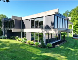 Expert Contractors at Huskie Exteriors Install Windows on Home