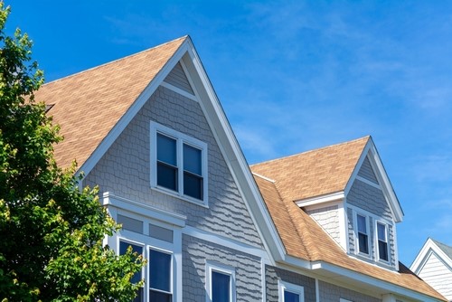 Steeply pitched residential roof with architectural details