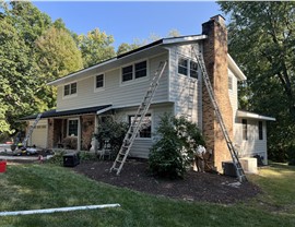 Damaged Gutters and Aging Roof – Pre-Remodel Exterior Damaged gutters and aging shingles on a Rockford, IL home before renovation by Huskie Exteriors