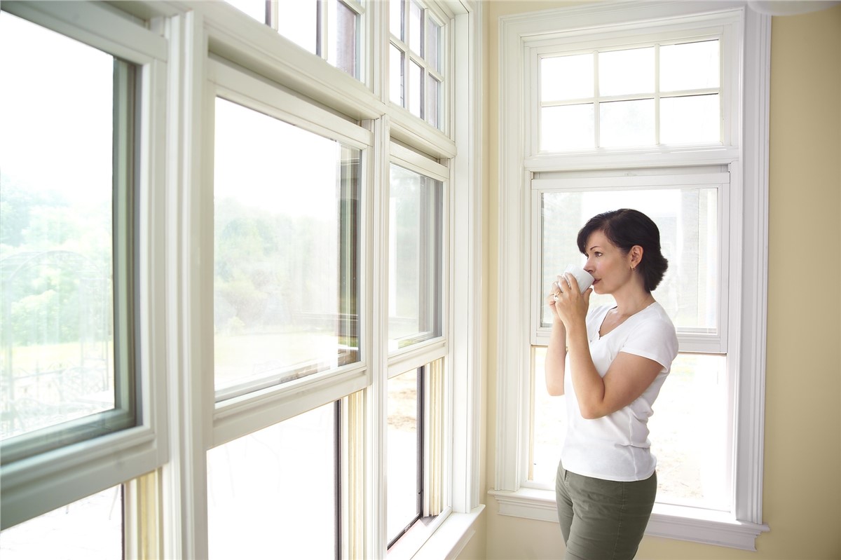 Woman Looking Out Her Windows