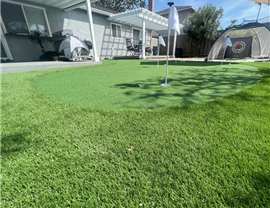 residential artificial turf putting green installation in backyard