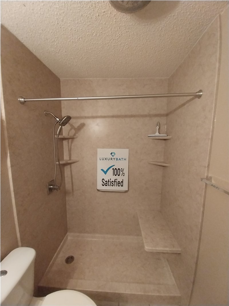 Finished walk-in shower after tub-to-shower conversion in Wichita Falls TX with acrylic wall surround and built-in seating