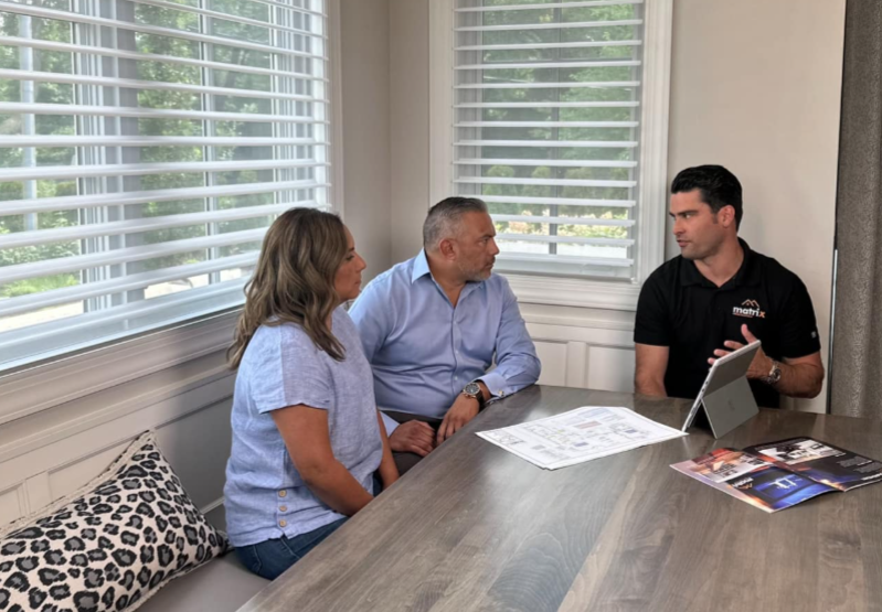 Sales representative discussing financing with their customer for their basement remodel