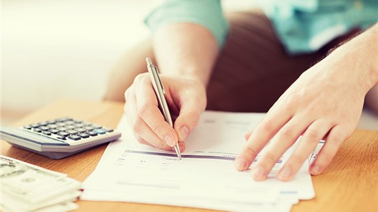 Person filling out financing forms