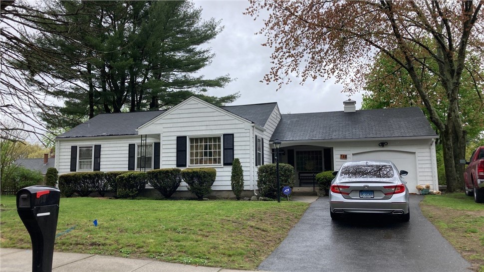 Residential roof replacement in Springfield MA by Millstream Construction with new architectural shingles installed.