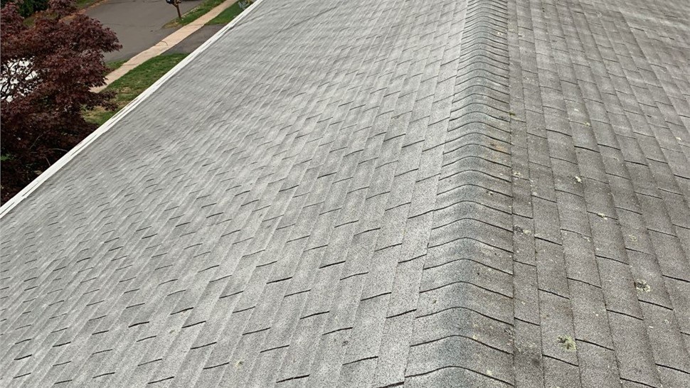New architectural shingle roof installed on a home in Berlin, CT after removing old warped and moss-covered shingles.