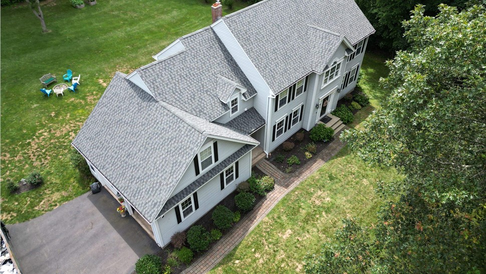 Completed roof replacement on a home in Glastonbury, CT with new architectural shingles installed by Millstream Construction.