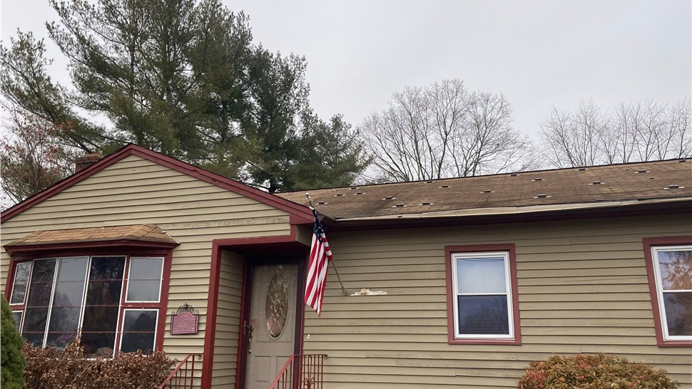 Newington CT roof replacement with old solar panels removed and new architectural shingles installed.