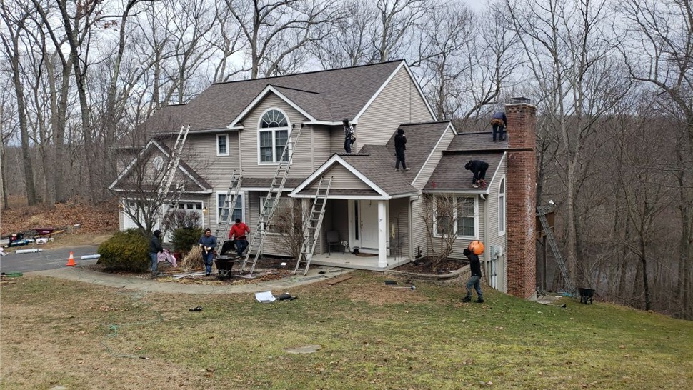 Old asphalt roof with worn shingles during Millstream Construction replacement in East Hampton CT