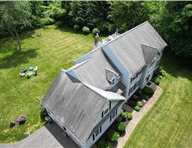 Completed roof replacement on a home in Glastonbury, CT with new architectural shingles installed by Millstream Construction.