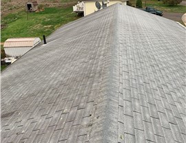 New architectural shingle roof installed on a home in Berlin, CT after removing old warped and moss-covered shingles.