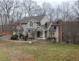 Old asphalt roof with worn shingles during Millstream Construction replacement in East Hampton CT
