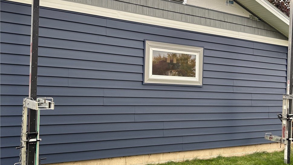 Patio Doors, Seamless Gutters, Siding, Windows Project in Roland, IA by Midwest Construction