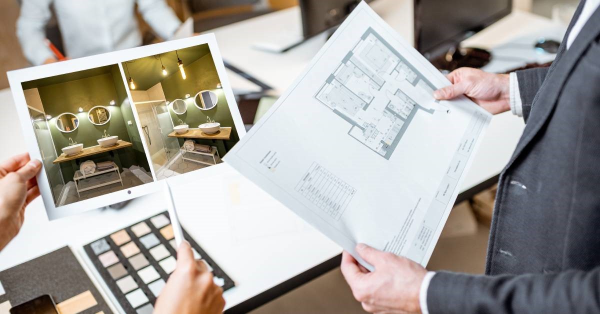 An interior designer showing their client images of potential bathroom remodel ideals, which include open-storage concepts.