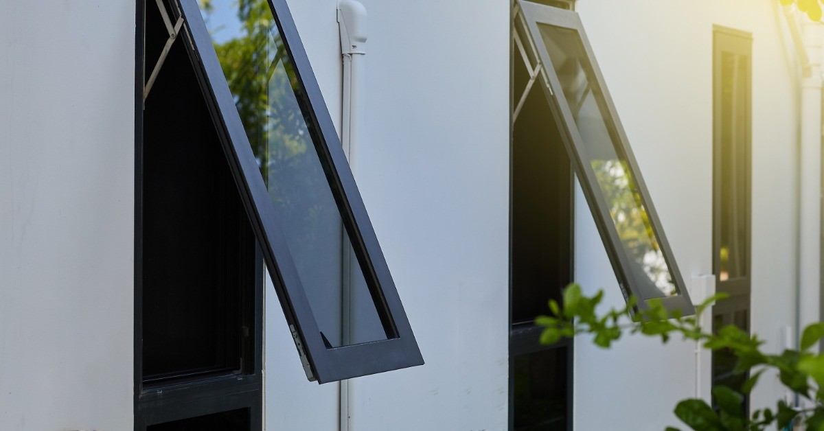 Two windows are opened up to the outside while a third window in the background is still closed.