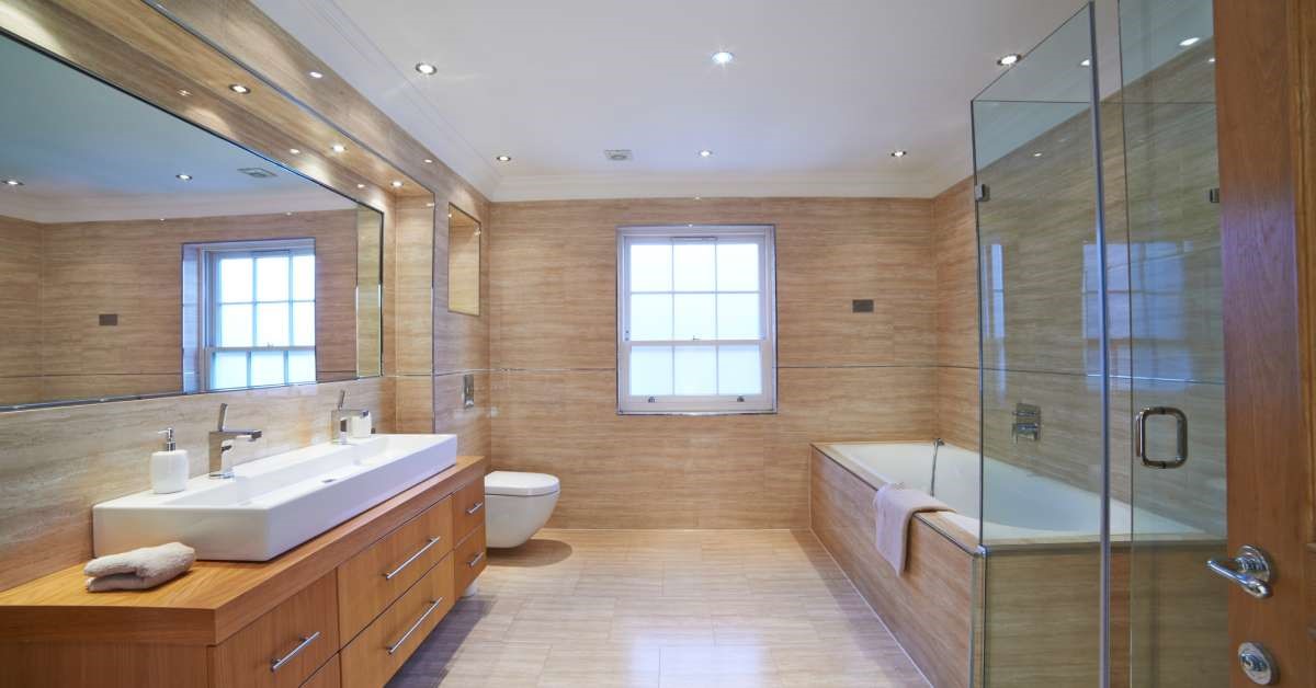 A modern and luxurious primary bathroom boasting the right balance of natural and artificial light sources.