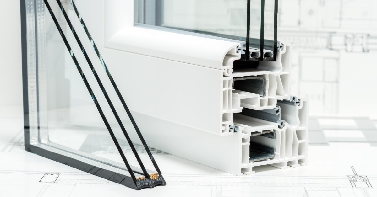 Three pieces of glass cut into the shape of a triangle are set up next to each other. Beside them is a cross section of a window.