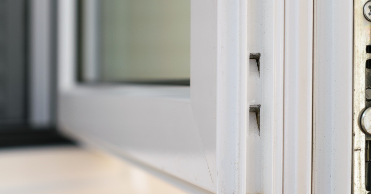 The corner joint detail of a recently replaced aluminum casement window, showcasing its superior durability.