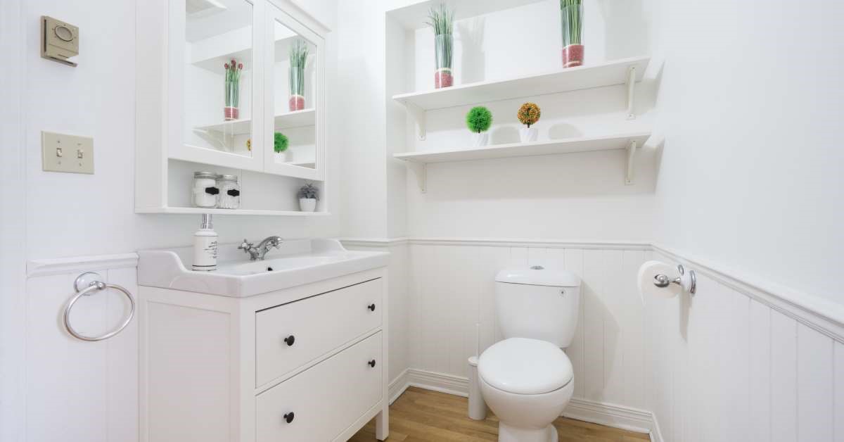 A small, recently renovated home bathroom that boasts smart storage solutions to maximize the functionality of the space.