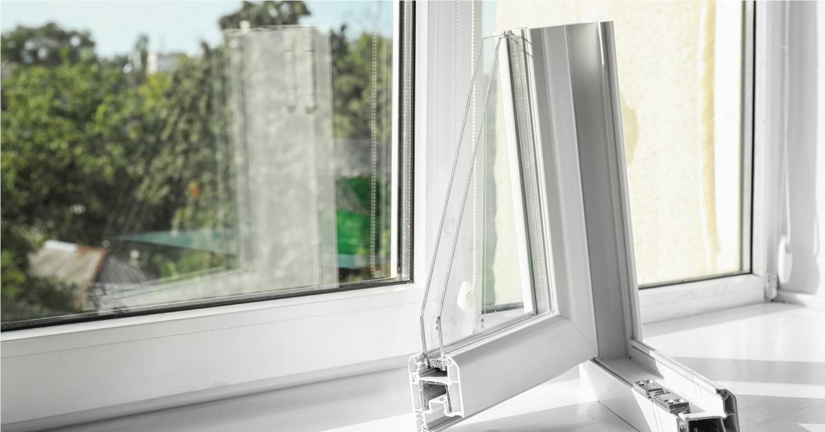 Sample section of a corner of a double-paned window with a white frame resting on a wide white window sill