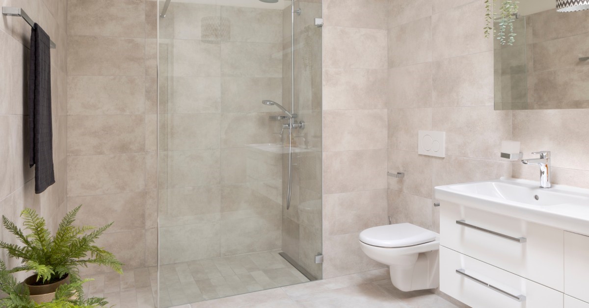 A modern and bright residential bathroom, complete with an accessible and stylish barrier-free shower.