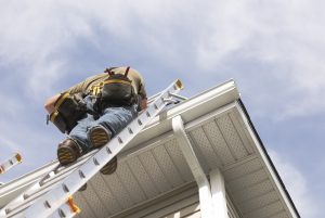 Person on ladder at roof