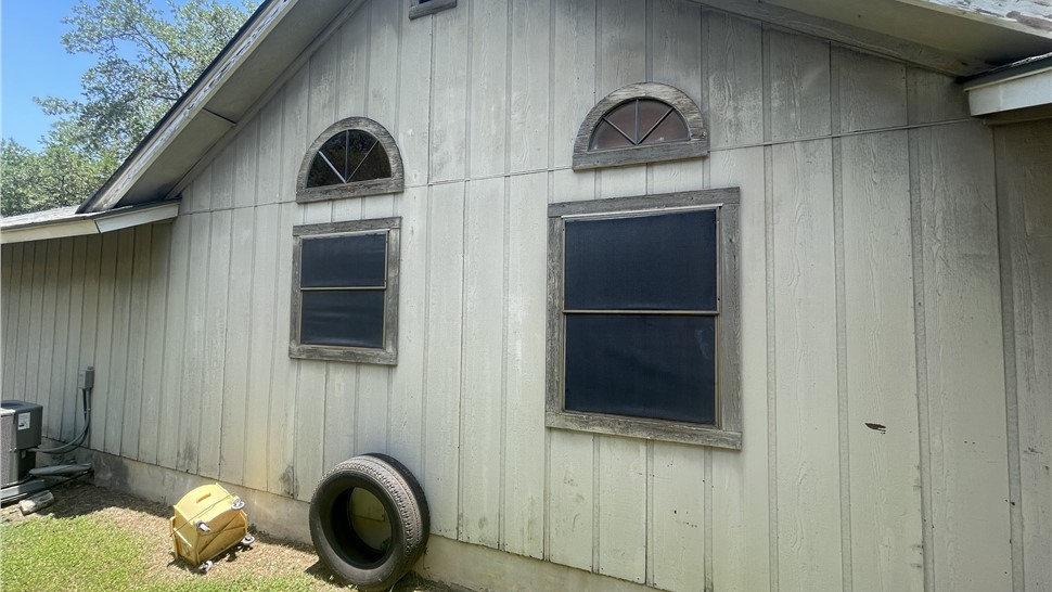 Before Hardie siding and Andersen window replacement on Austin TX home with aged exterior siding