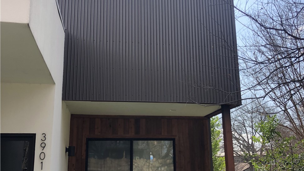 Custom corrugated metal siding installation on modern home in Austin TX