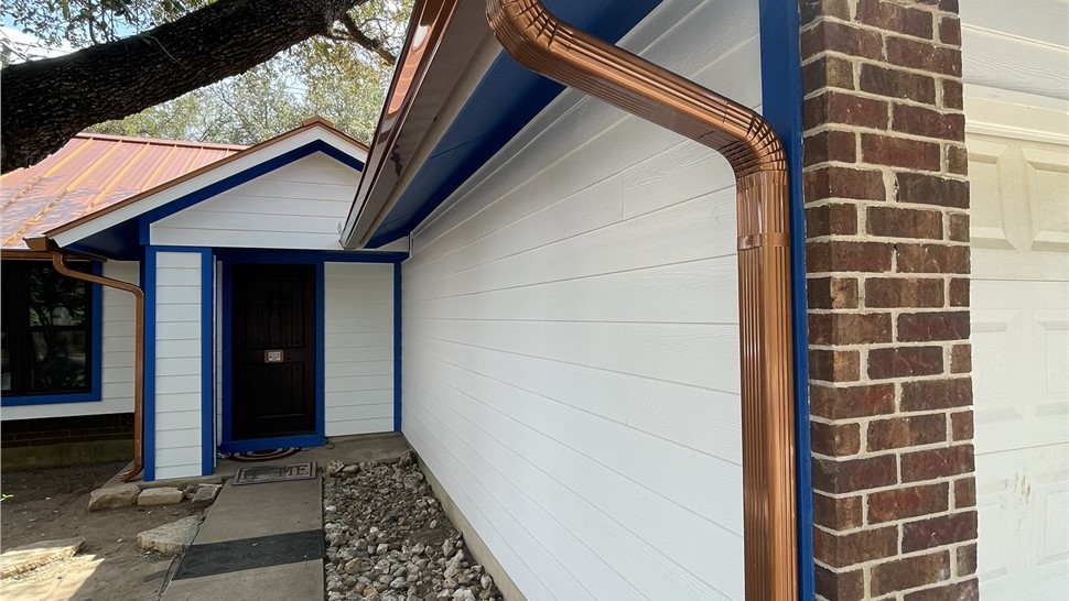 Hardie siding soffit fascia and trim with Andersen black windows in Austin TX