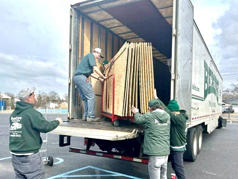 Young girl with Sea Cure sign at sports field