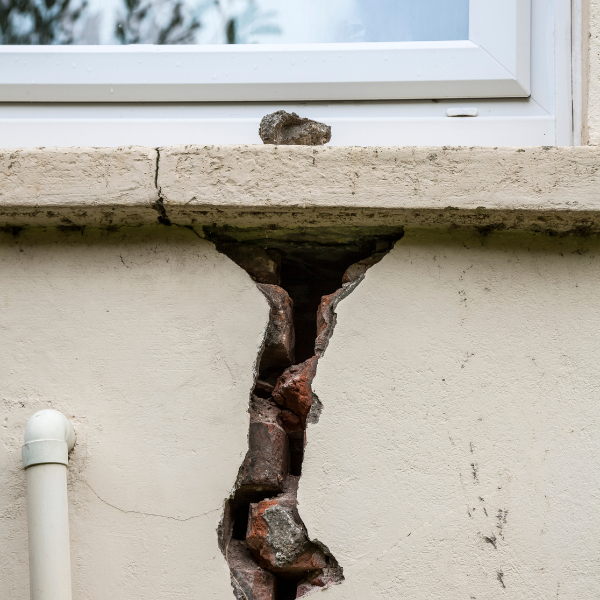 An image of a wide vertical crack in a foundation wall.