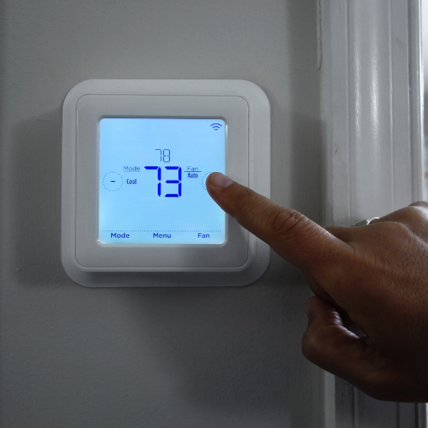 An image representing a homeowner experiencing better energy efficiency with lower AC expenditure after new siding. 