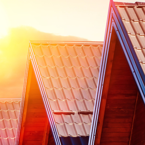 An image showing a brick house with a metal roof withstanding hot weather.