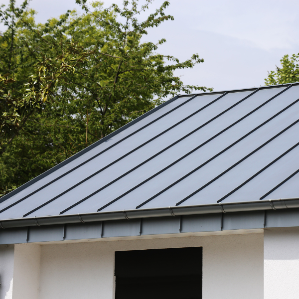 An image showing a house with a new metal roof.