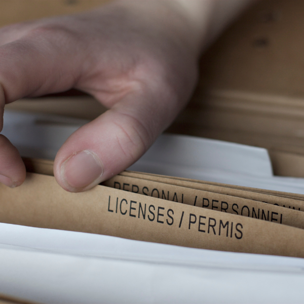  A photograph showing a siding contractors license and insurance documents.