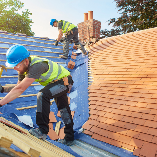 An image showing an energy-efficient home with a new tile roof installation.