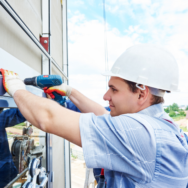 An image showing professionals installing metal horizontal siding.