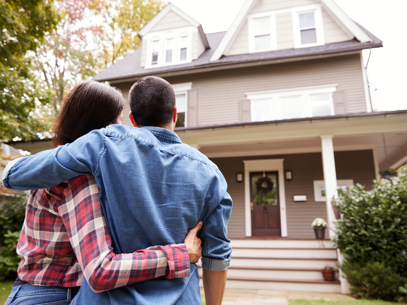 A homeowner undecided on which exterior siding to choose. 