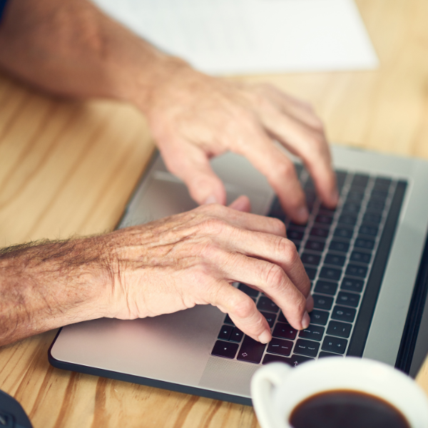 An image of a person researching siding repair companies on a computer.