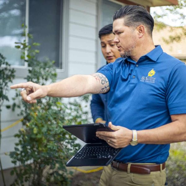 An image showing a professional assessing foundation cracks.