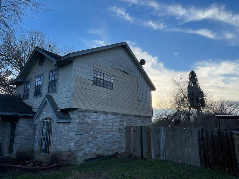 An image showing a house with damaged siding.